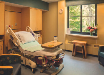 A bed made up in the Birthing Suite