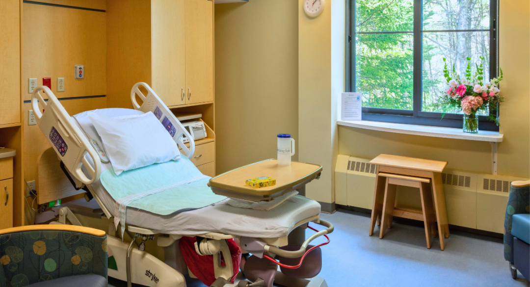 A bed made up in the Birthing Suite