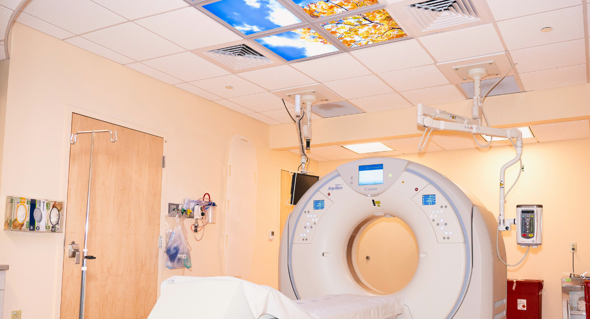 A modern MRI machine is shown in a clean and well-lit imaging room, emphasizing advanced medical technology and patient care