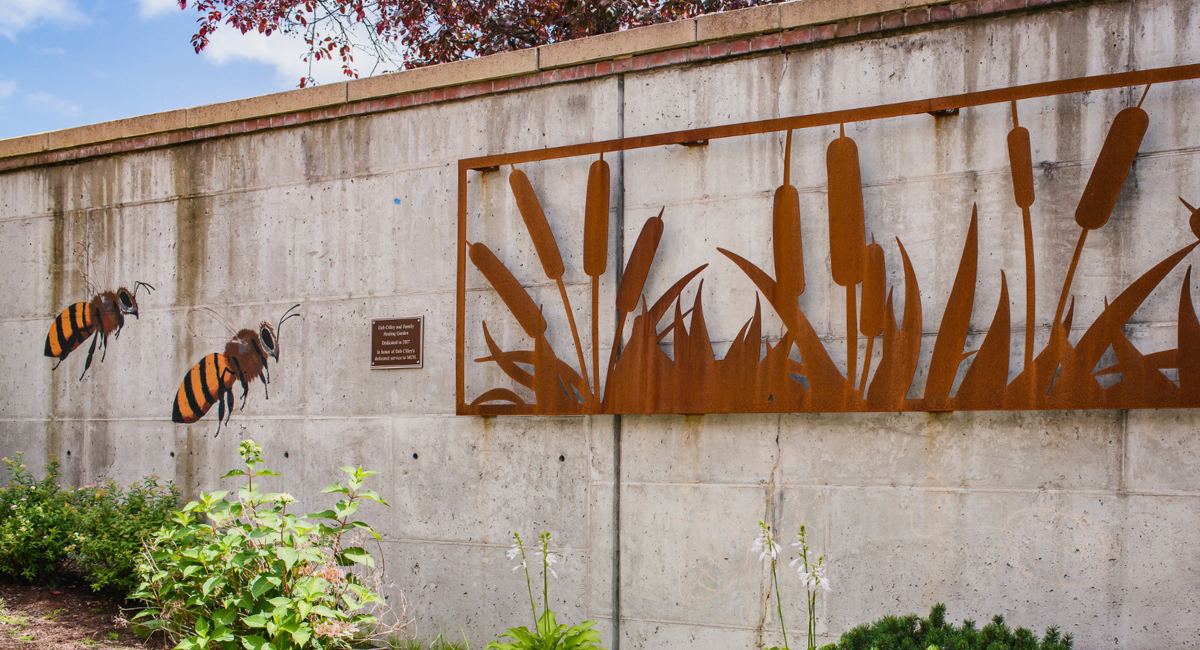 Outdoor mural at Monadnock Community Hospital featuring bees and cattails, symbolizing the hospital's dedication to holistic care, including the expert services of oncology specialists