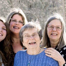 Madison Wright, Jennifer Wright, Gail Niskala, and Deborah Wright smiling and standing together outdoors in a snowy setting, showing three generations of a family