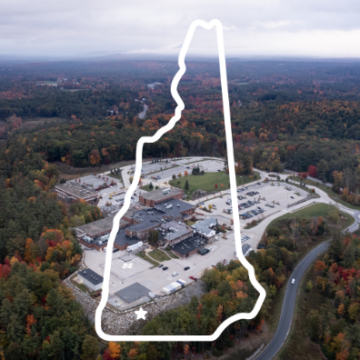aerial photo of the hospital with an outline of the state of new hampshire superimposed on top