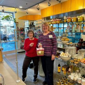 Volunteers show off the giveaway from our reopening celebration