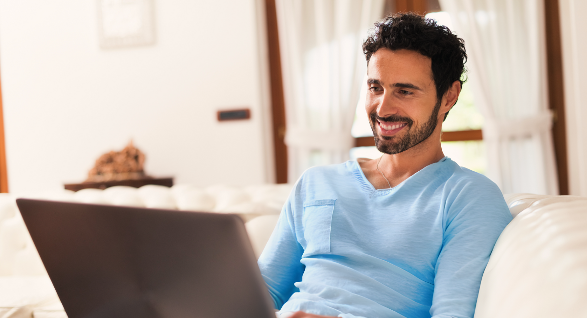 Smiling man at home in Peterborough, NH, accessing his healthcare information through the Monadnock Community Hospital patient portal