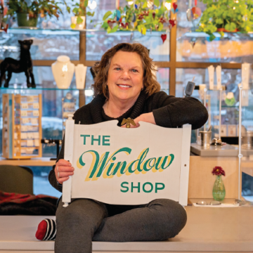 Toni Gildone with a vintage Window Shop sign