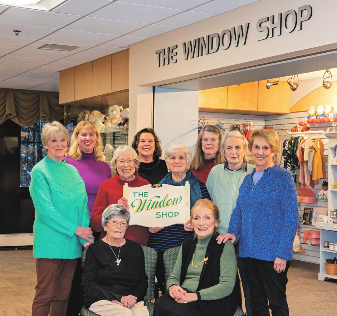 Window Shop volunteers standing left to right: Barbara Pendleton, Liz Kenney, Roon Frost, Toni Gildone (MCH Window Shop Manager and Volunteer Coordinator), Steffie Kyte, Shelly Zinsmeister, Judy Edelkind, and Carole Connor Sitting left to right: Connie Boyd and Louise Vickory