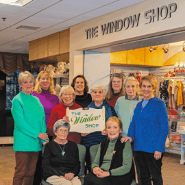 Window Shop volunteers standing left to right: Barbara Pendleton, Liz Kenney, Roon Frost, Toni Gildone (MCH Window Shop Manager and Volunteer Coordinator), Steffie Kyte, Shelly Zinsmeister, Judy Edelkind, and Carole Connor Sitting left to right: Connie Boyd and Louise Vickory