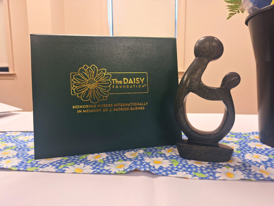 DAISY Award certificate holder and The Healer's Touch handmade stone statue. Made of serpentine stone, this beautiful sculpture symbolizes the unique relationship between nurses, patients, and families. 