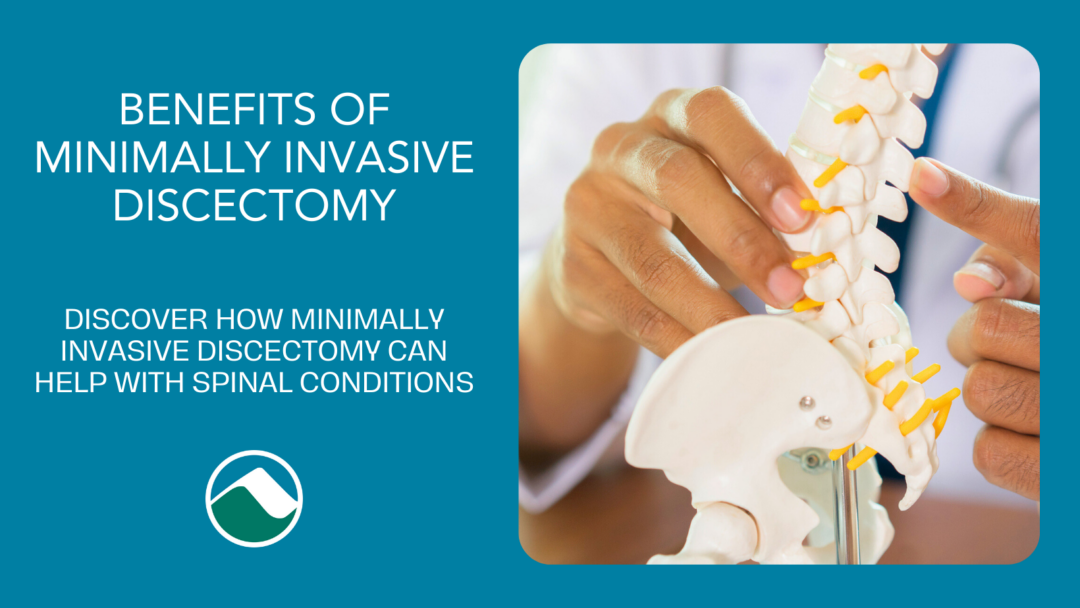 Teal background with the title "Benefits of Minimally Invasive Discectomy: Discover how minimally invasive discectomy can help with spinal conditions." The image shows a close-up of a doctor's hands holding a model of the spine. The Monadnock Community Hospital logo is at the bottom.