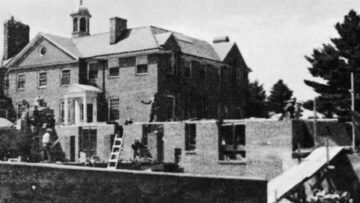 A historical black-and-white photo showing the construction of Monadnock Community Hospital in 1949, with workers building the structure and scaffolding around the site.