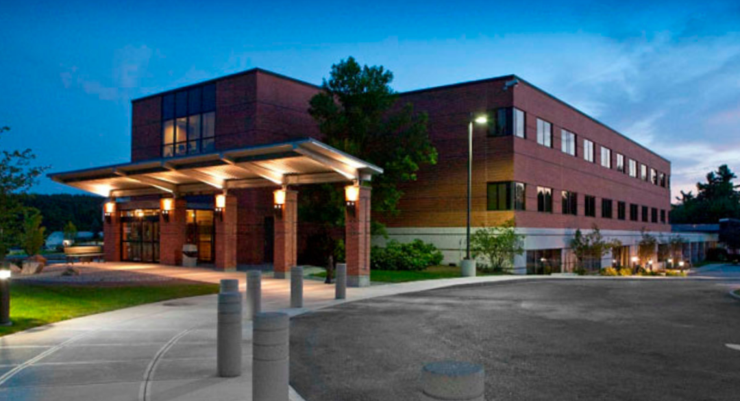 Exterior view of Monadnock Community Hospital at dusk, highlighting the welcoming entrance. Maximize health insurance benefits by scheduling your care at our state-of-the-art facility before deductibles reset