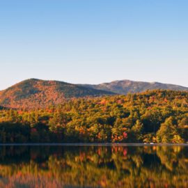 Stunning image of Dublin with Mount Monadnock, a picturesque lake, and vibrant autumn foliage