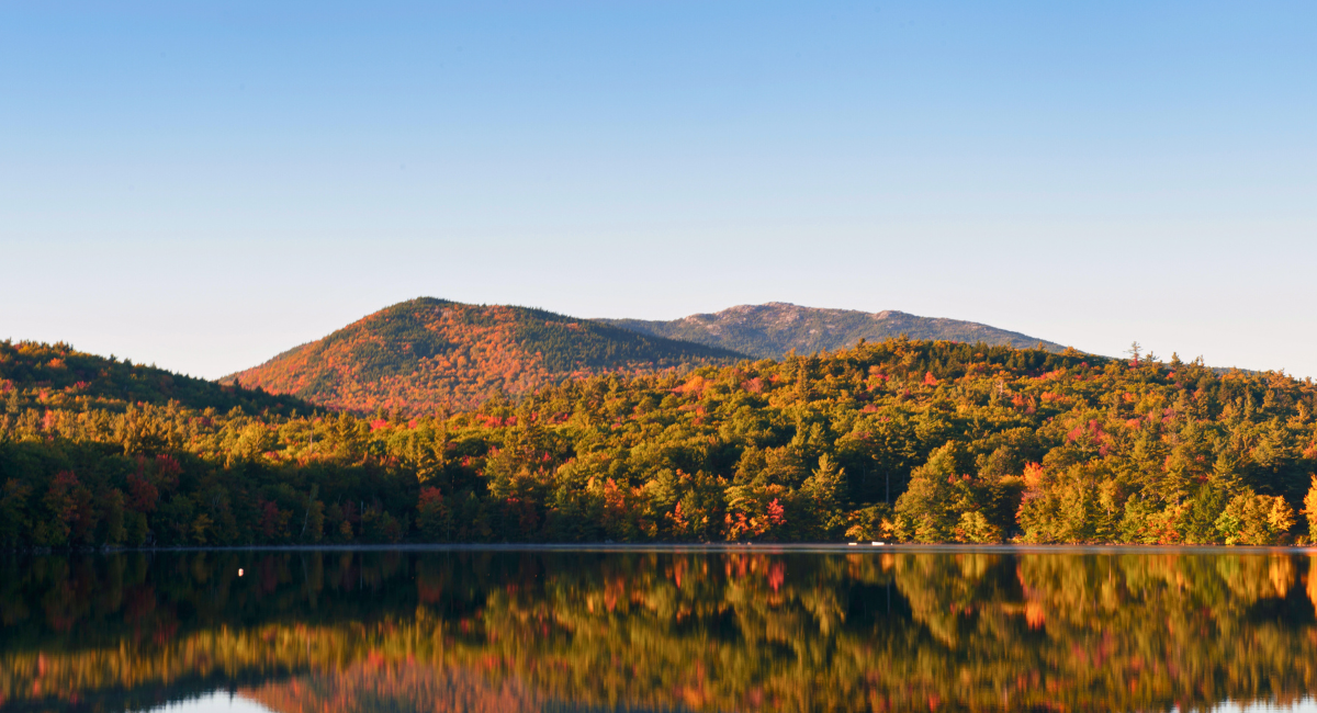 A scenic view of Mount Monadnock surrounded by fall foliage, symbolizing the community served by Monadnock Community Hospital and their access to local specialists