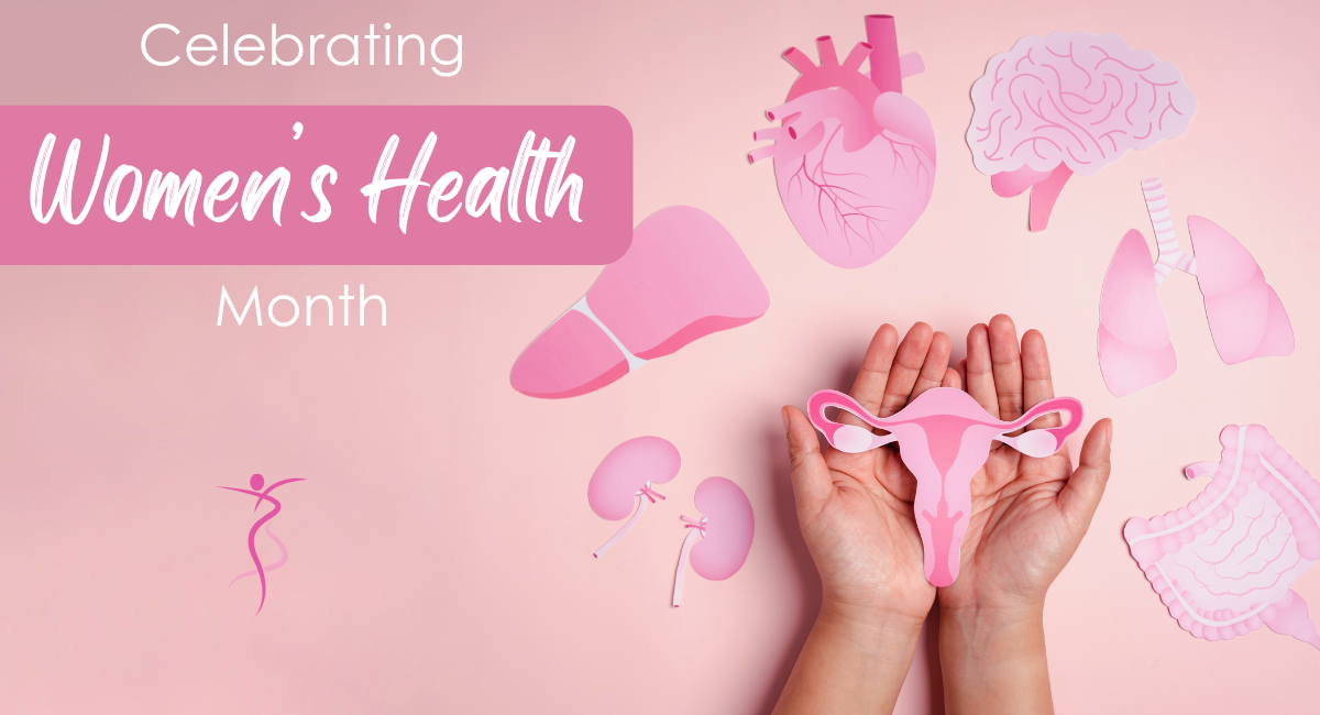Hands gently holding a pink paper cutout of a female reproductive system, surrounded by other pink anatomical cutouts including a heart, brain, lungs, kidneys, and digestive system on a soft pink background. Text reads “Celebrating Women’s Health Month.”