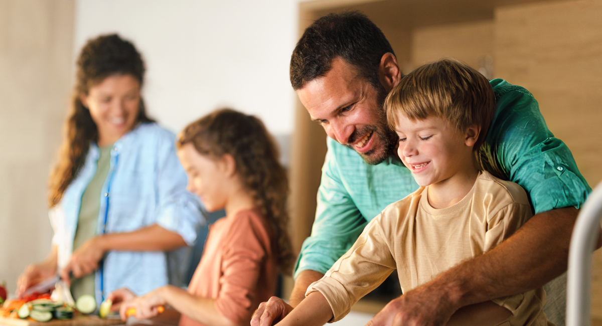 Family preparing a meal together, highlighting the role of pediatric care in fostering healthy habits for children