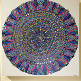 Intricate mandala artwork featuring vibrant blues, pinks, and greens, intricately detailed with a kaleidoscope pattern, creating a mesmerizing visual effect