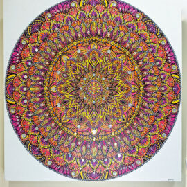 Colorful mandala painting with intricate details in shades of orange, pink, and yellow, forming a symmetrical, captivating design