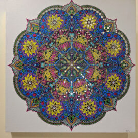 Elaborate mandala artwork with a complex, symmetrical design in vivid colors, including blue, yellow, and pink, featuring floral and geometric patterns