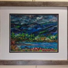 Framed painting of a dramatic mountain landscape with dark, stormy skies. The vibrant colors in the foreground contrast with the moody blues and greens of the mountains, creating a sense of depth and atmosphere