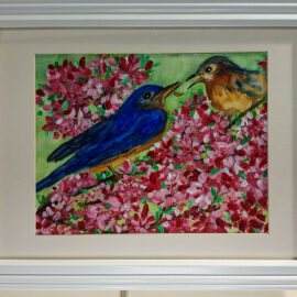 A colorful painting of two bluebirds amidst a pink floral backdrop. One bird is feeding the other, creating a tender scene of nature. The painting is framed in a classic white frame, enhancing the vivid colors of the birds and flowers.