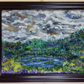 A painting capturing a vibrant landscape with a lush green forest and a small pond under a dynamic, cloudy sky. The artwork is rich in shades of green, blue, and purple, emphasizing the natural beauty of the scene. The painting is framed in a dark wooden frame and mounted on a light wall.