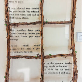 A poetic artwork titled 'Time to Grow' by Jam Rizzi, featuring text written on glass panes framed by intertwined vines. The text reflects themes of growth, sacrifice, and belonging, emphasizing the nurturing and supportive aspects of nature and human relationships