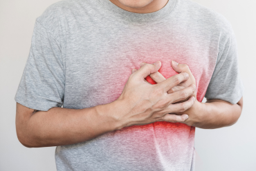 A man experiencing chest pain, highlighting heart care services available through comprehensive cardiology services in Peterborough, NH