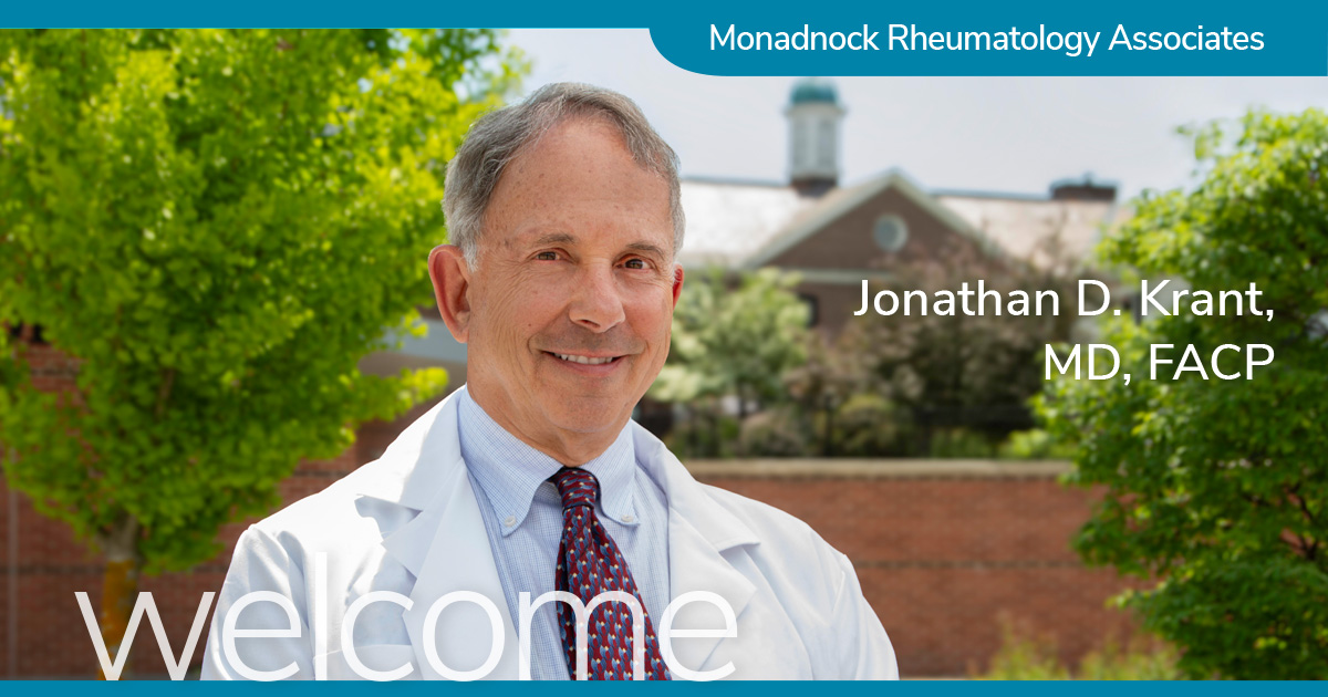 Dr. Jonathan D. Krant, MD, FACP, of Monadnock Rheumatology Associates, smiling outdoors with the Parmelee hospital building and green trees in the background. The word 'welcome' is displayed at the bottom of the image