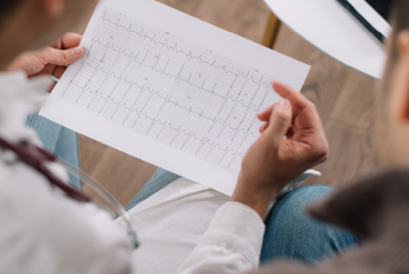 A doctor reviewing an EKG with a patient, illustrating access to cardiology specialists at Monadnock Community Hospital in Peterborough, NH