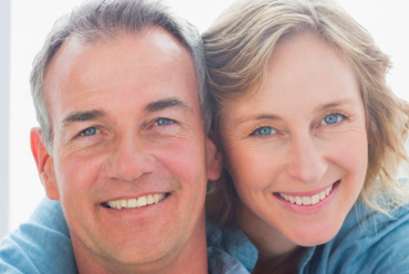 A smiling middle-aged couple, representing the peace of mind that comes with access to specialists at Monadnock Community Hospital