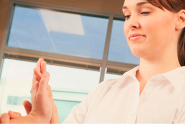 A therapist guiding a patient through hand exercises, depicting occupational therapy services at Monadnock Community Hospital