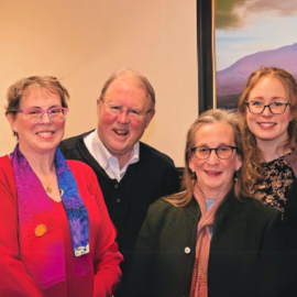 Members of the Patient & Family Advisory Council at Monadnock Community Hospital. From left to right: Denise Lord, VP of Organizational Performance; Vicky Rank; John Richards; Judy Unger-Clark; Molly Rajaniemi, Patient Experience Coordinator; and Lisa McInnis, MHP Practice Liaison. The group stands in front of a landscape painting, smiling, and showcasing their commitment to improving patient care and community engagement.