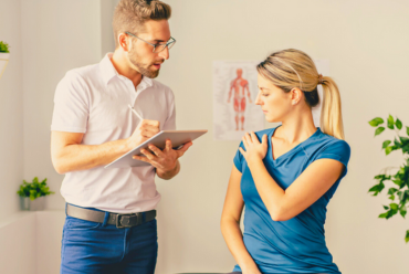 A rehabilitation therapist assisting a patient with mobility exercises, illustrating rehabilitation services at Monadnock Community Hospital