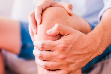 A patient holds their knee