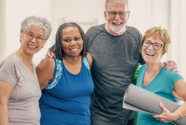 A smiling group of older people in athletic clothing