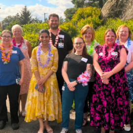 A group photo of Monadnock Community Hospital staff members standing together outside the hospital, smiling and showcasing a diverse team committed to providing exceptional care.