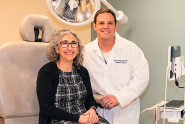 A smiling patient poses with Dr Kwitkin