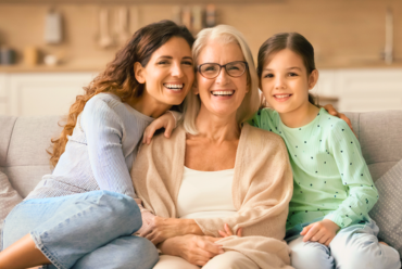 A group of smiling women of various generations