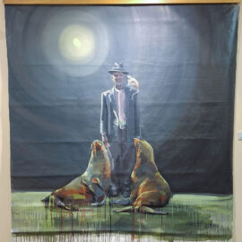 A painting of a man in a suit and hat standing under a full moon, flanked by two sea lions gazing up at him. The background is dark with a hazy glow around the moon, giving a mysterious nighttime atmosphere