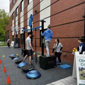 The grand opening of a new outdoor turf area at the hospital, showing employees and community members exploring the fitness facilities