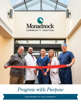 Five healthcare professionals stand together smiling as they cut a red ribbon at Monadnock Community Hospital under a skylight, celebrating the launch of a new initiative. The text below reads “Progress with Purpose – 2025 Report to Our Community.”
