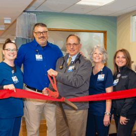 Dr. Jonathan Krant and the Monadnock Rheumatology Associates team stand together inside a clinical space with a red ribbon, marking their practice launch.