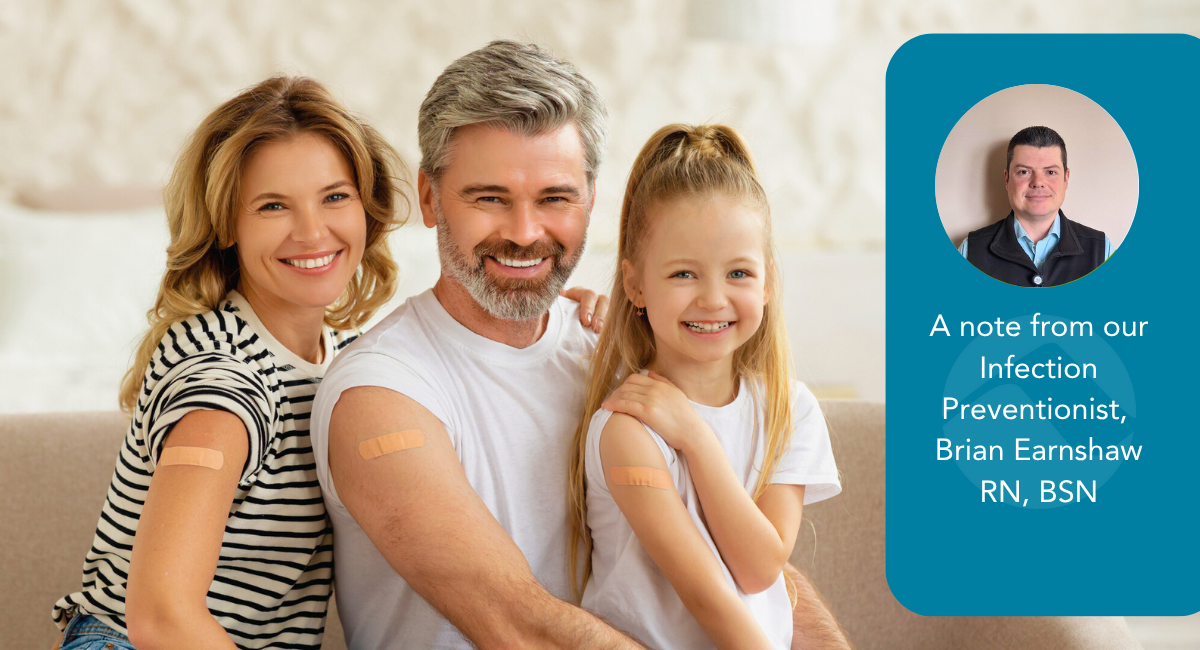 A family of three—mother, father, and young daughter—smile together on a couch with small adhesive bandages on their upper arms, indicating recent vaccinations. On the right, a blue panel features a circular headshot of Brian Earnshaw, RN, BSN, with the text: "A note from our Infection Preventionist, Brian Earnshaw, RN, BSN." The image emphasizes family health and professional vaccine guidance.