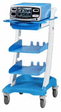 A blue-and-white Valleylab FT10 Electrosurgical Generator on a wheeled cart, featuring a touchscreen display and control panel. The unit represents the advanced energy platform used by Monadnock Community Hospital surgeons to deliver precise, consistent tissue effects and safer surgical outcomes through real-time energy monitoring.