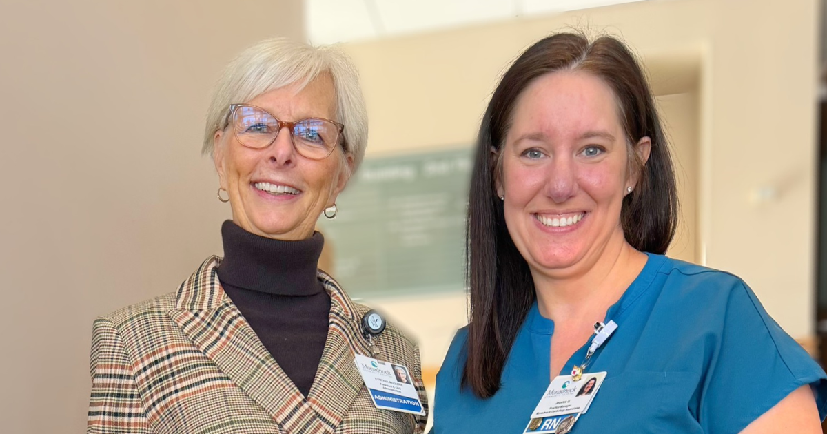 Cynthia K McGuire former President and CEO of Monadnock Community Hospital and Jessica Gifford of Monadnock Cardiology Associates smile together in a hospital hallway