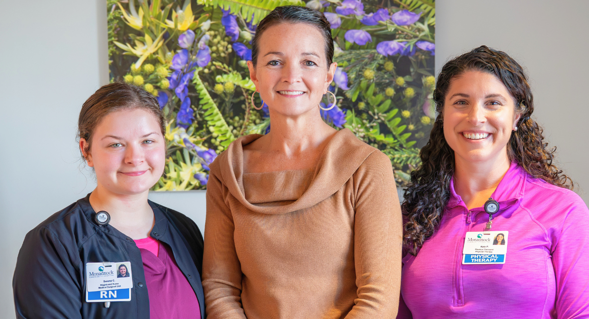 Serena C., RN [left], Laura Akerley [center], and Kate Pellegrino, PT, DPT [right], stand together and smile at Monadnock Community Hospital.