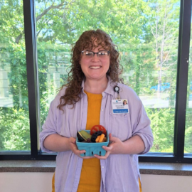 Whitney Hightower, MS, RDN, LD, Registered Dietitian at Monadnock Community Hospital, smiles while holding a basket of fresh fruits and vegetables. The image includes Core4 Weight Management Program branding and highlights the program's focus on sustainable healthy habits, nutrition education, and personalized support.