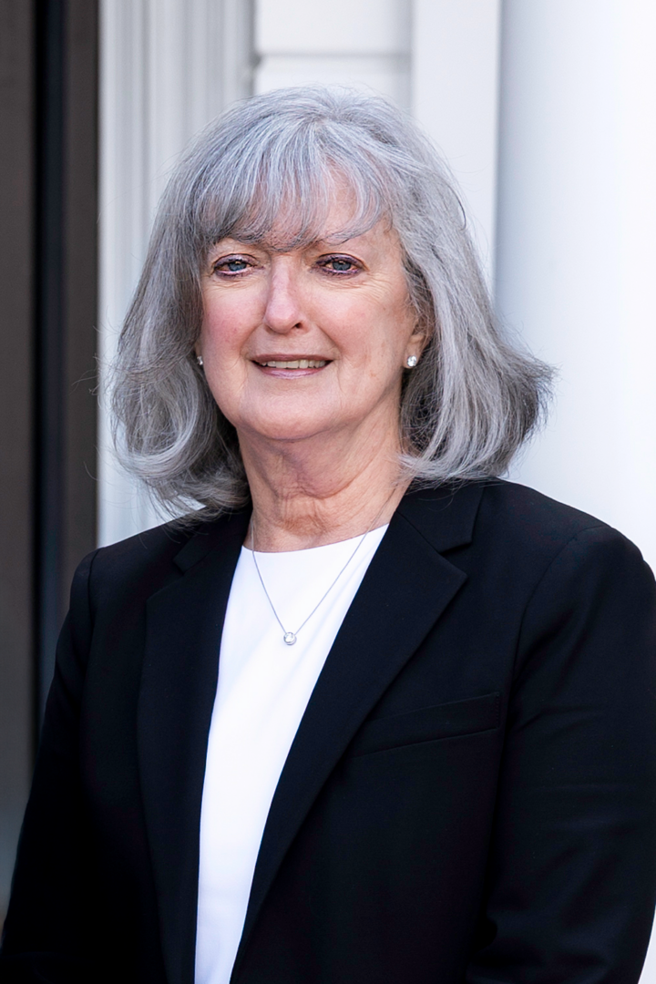 Linda Roche, member of the Monadnock Community Hospital Board of Trustees, standing outdoors in front of the hospital wearing a black blazer and white blouse.