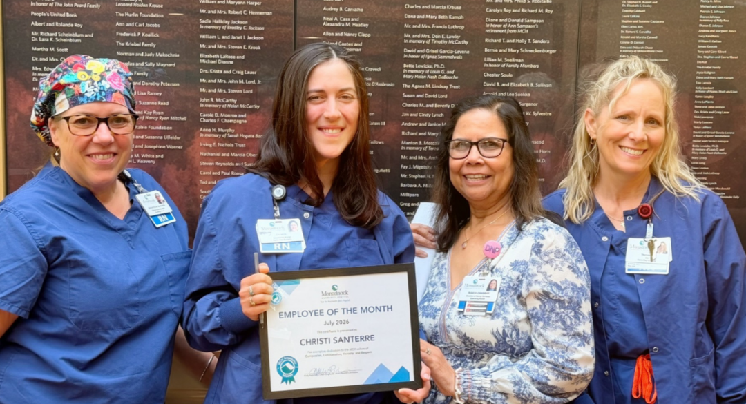 Christi Santerre, RN, stands with colleagues Sam, Sudesh, and Therese while holding her July 2026 Employee of the Month certificate at Monadnock Community Hospital.
