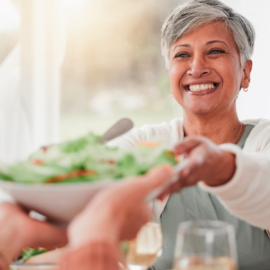 smiling woman sharing a salad